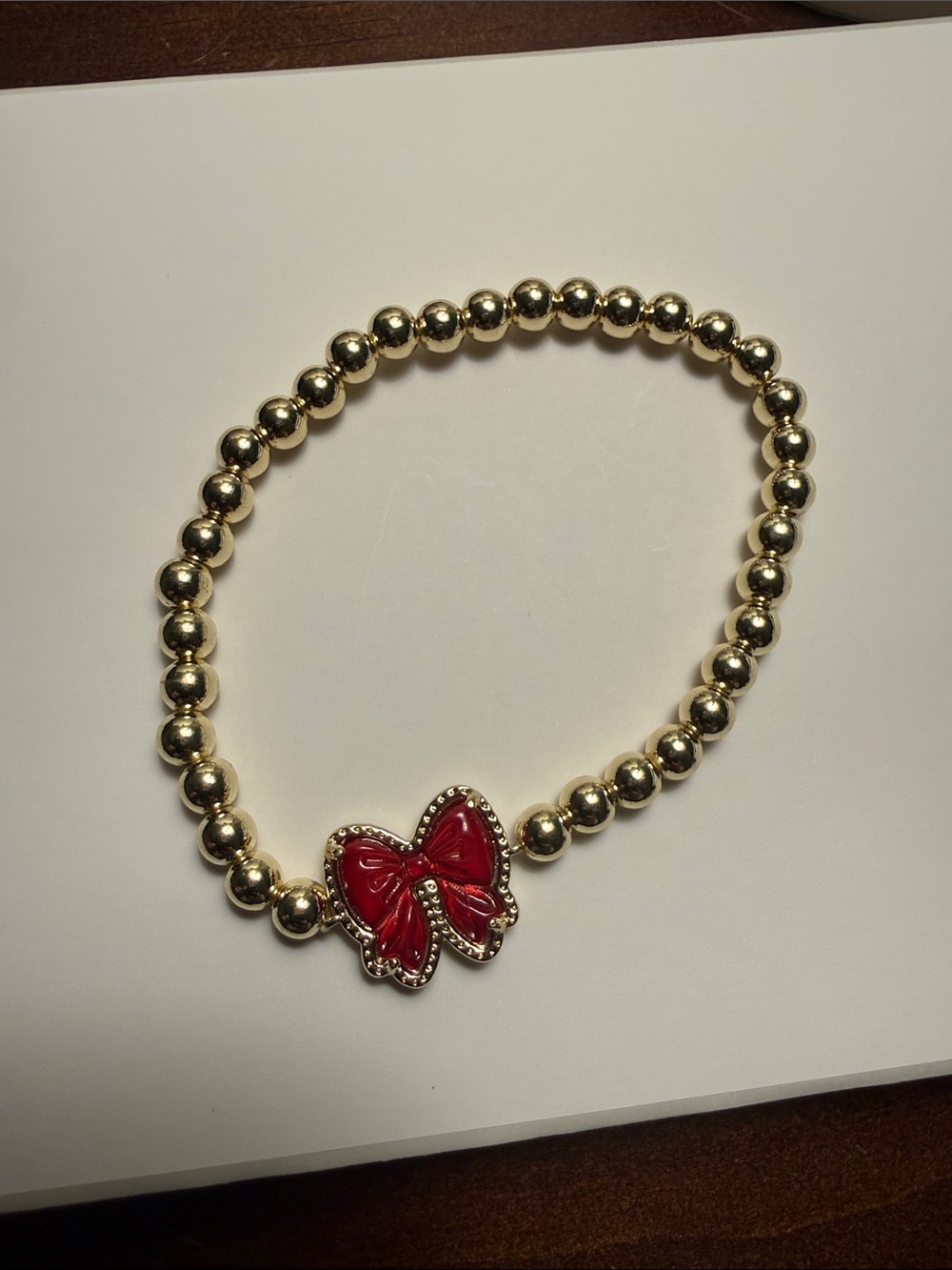 Kendra Scott Gold Beaded Bracelet with Red Bow Charm